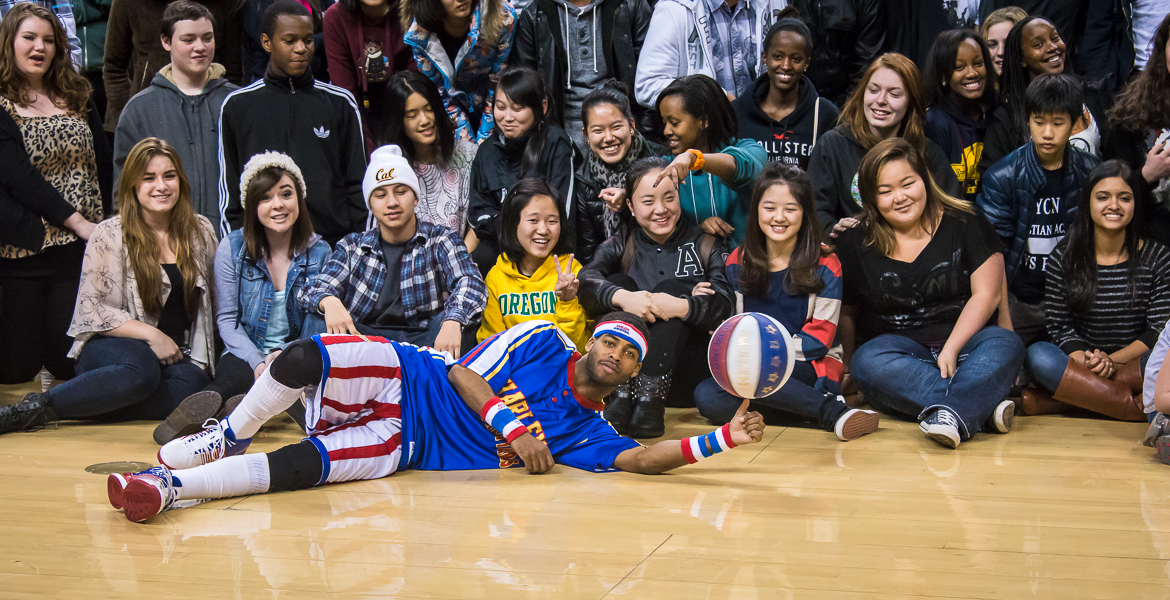 Canyonville Christian Academy students get a photo with Flea of the Harlem Globetrotters