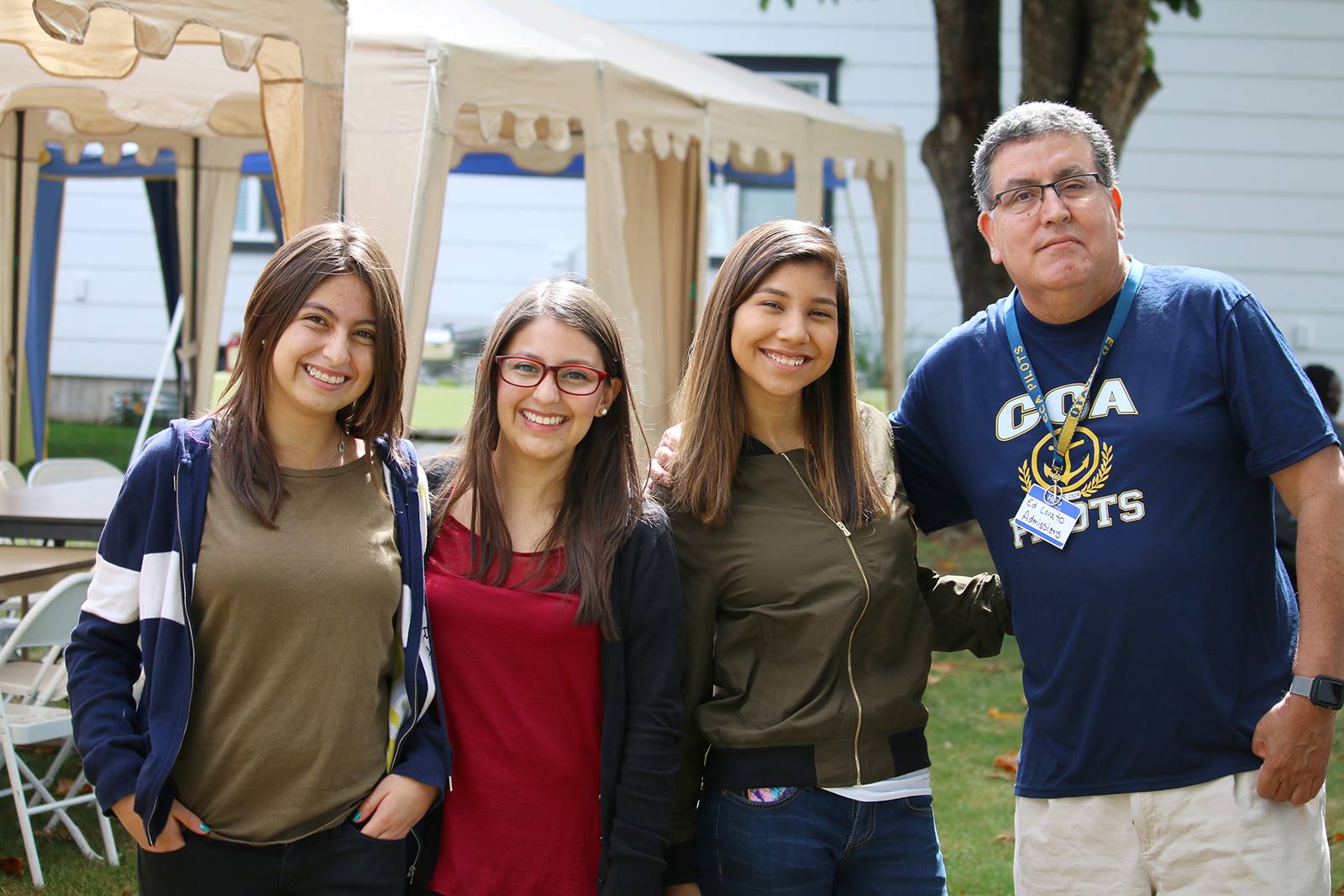 admissions director, Ed Lovato posing with Columbian students