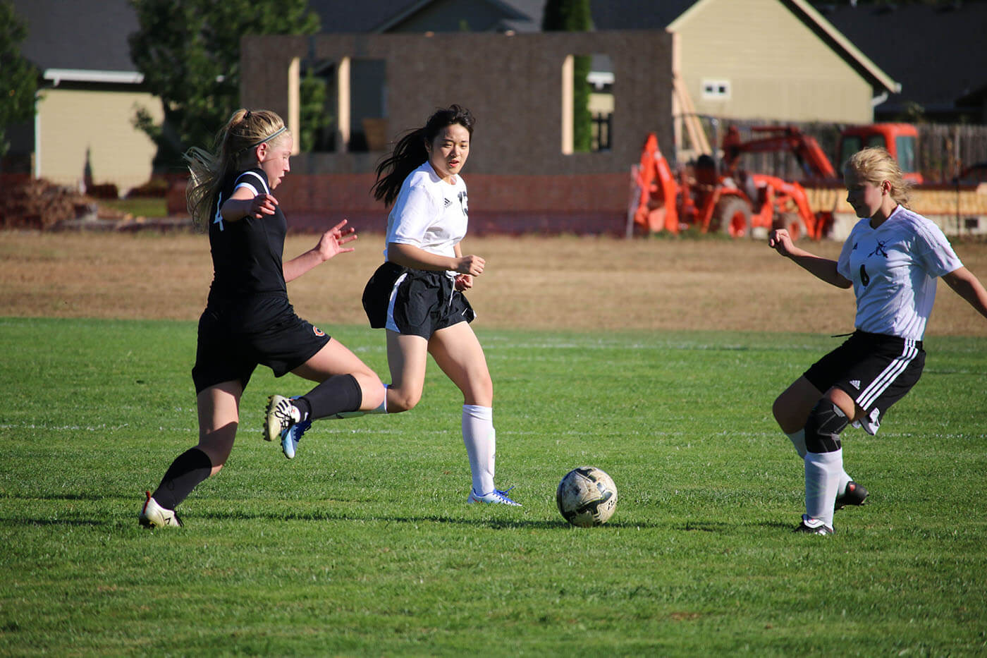 top christian boarding school, offers girls' soccer program, players take the ball, from opposing team